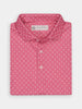 Folded pink shirt with a subtle white Donald Ross pattern, featuring a classic collar and three buttons. The fabric label displays a floral logo design.