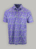 Purple short-sleeve shirt with vibrant green and white floral patterns on a plain gray background, conveying a summery, lively tone.