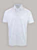 White polo shirt with a spread collar, featuring a scattered pattern of small blue and pink golf tees. The shirt conveys a casual, modern feel.