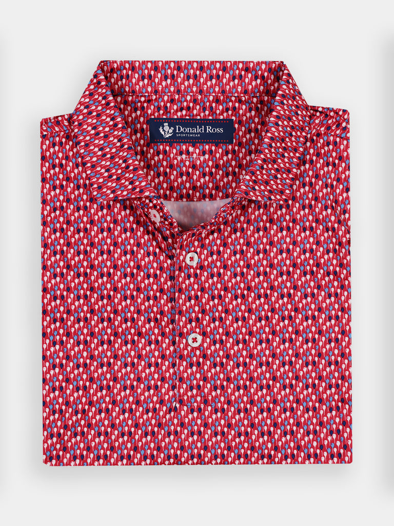 Folded red and white balloon patterned polo shirt with a collar and three white buttons