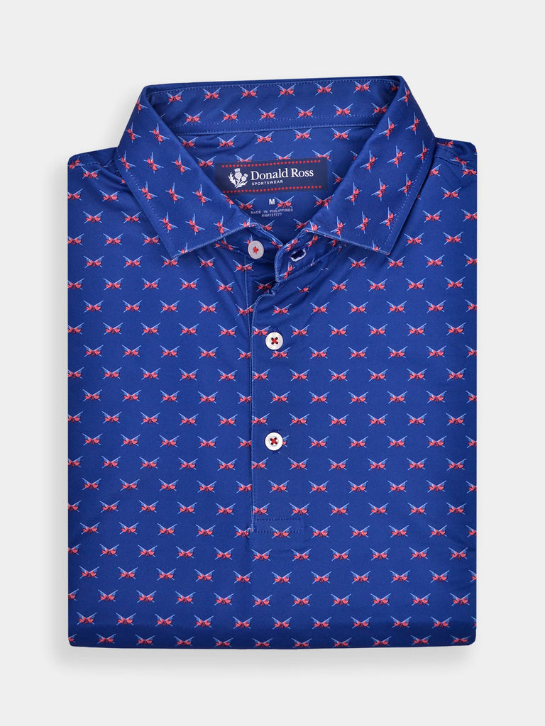 Blue polo shirt with a small red white and blue crossed flags, folded neatly. The collar is pointed, and three white buttons are visible.