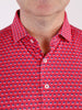 Close-up of a man's upper chest wearing a red shirt with small blue and white elephant patterns, buttoned up with white buttons, conveying a playful tone.