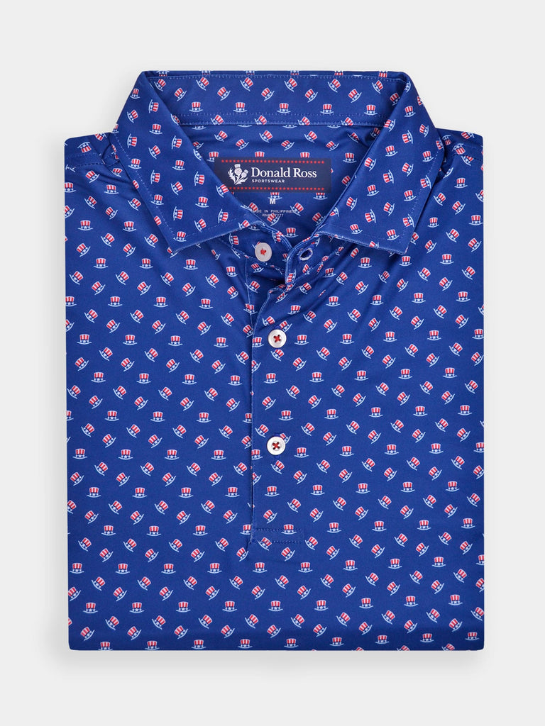 Blue polo shirt with a vibrant pattern of small red, white, and blue stars and stripes hats. The collar and button detail add a classic touch.
