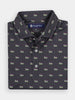 Dark gray button-up shirt folded neatly, adorned with a repeating pattern of small flags. The label reads "Donald Ross Sportswear." The shirt conveys a polished, casual style.
