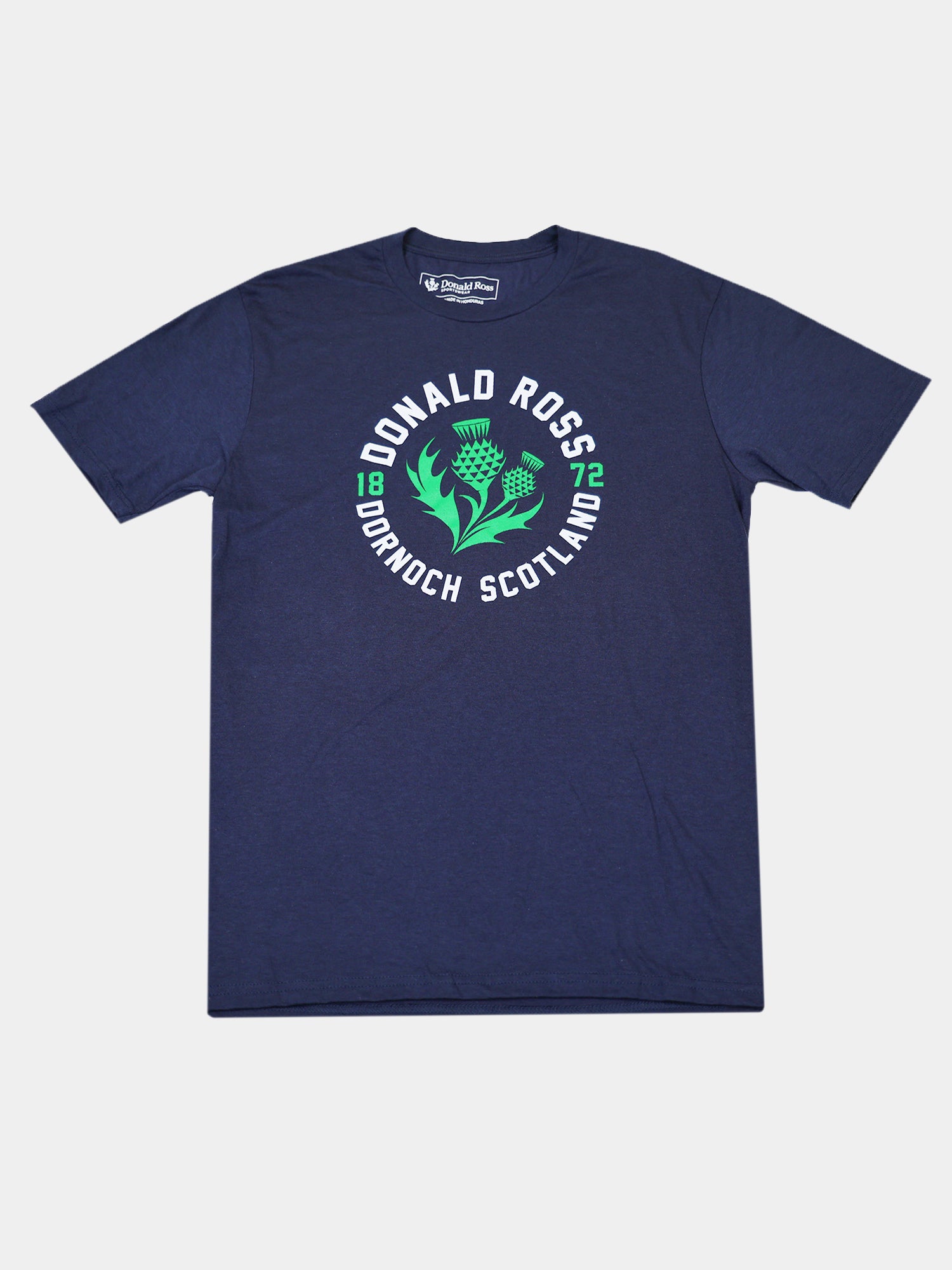 Navy blue T-shirt featuring white text "Donald Ross Dornoch Scotland" around a green thistle emblem. Numbers "18" and "72" appear on either side.
