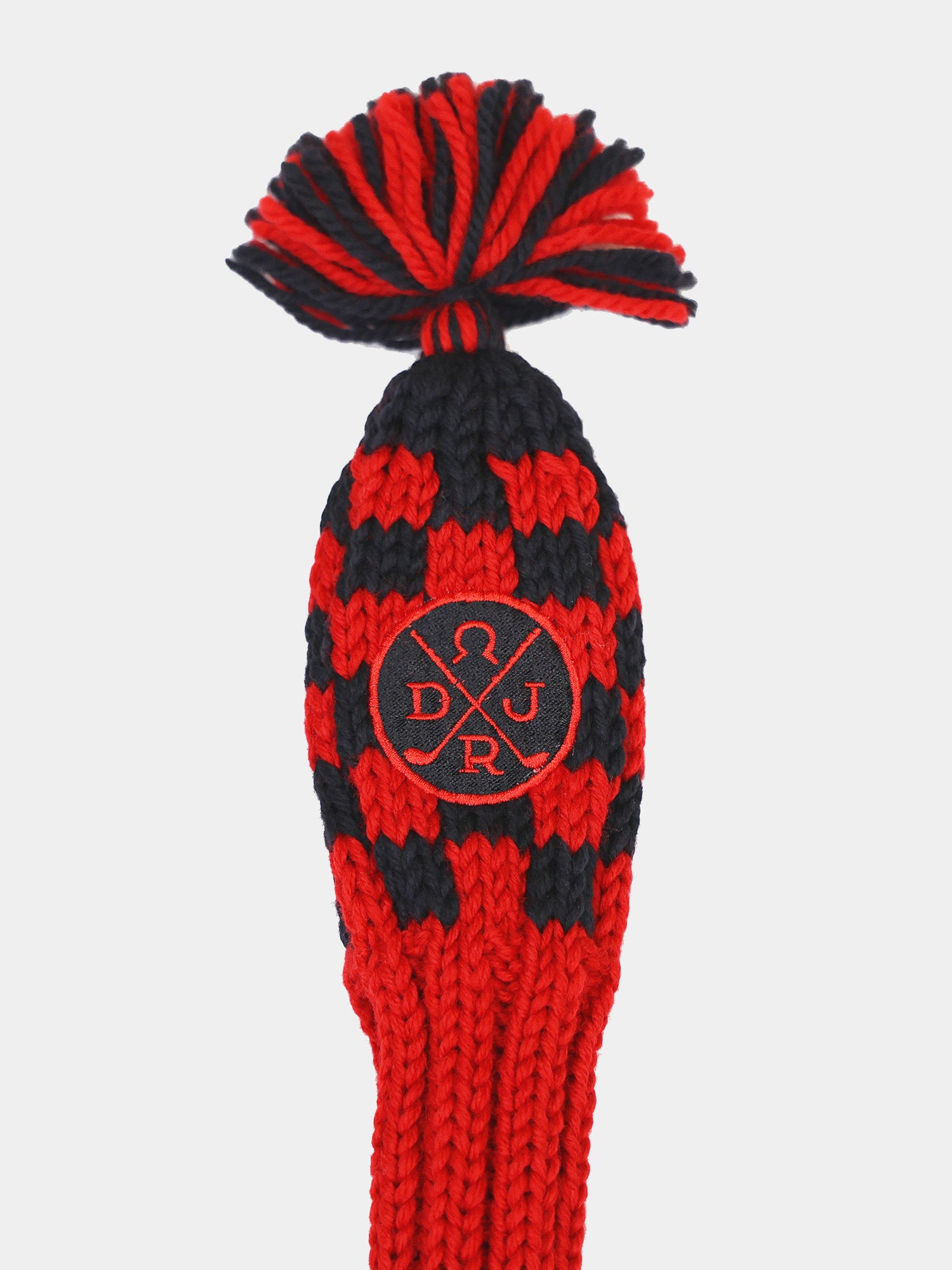 Red and black knitted golf club headcover with a pom-pom on top and an embroidered logo in the center.