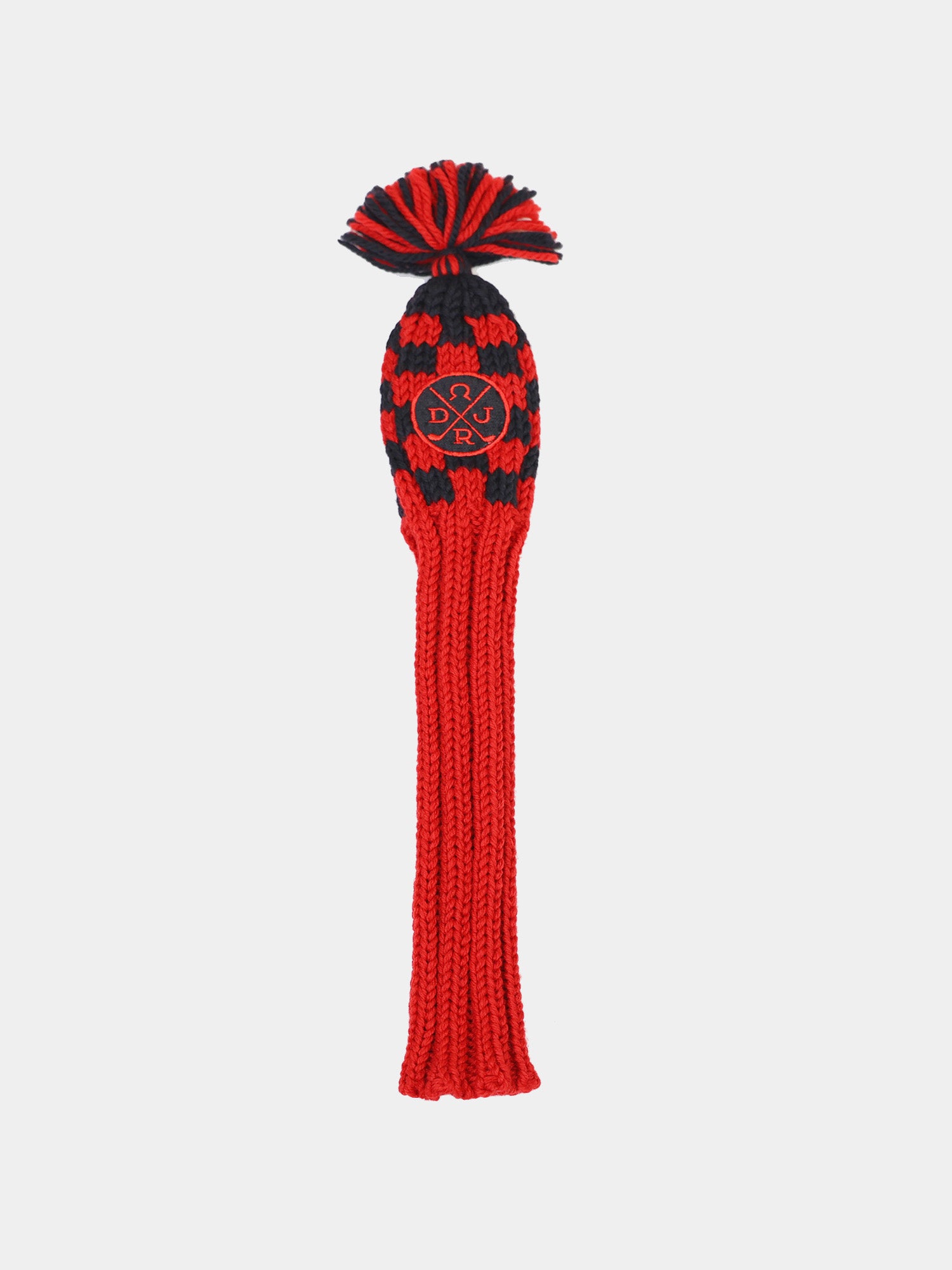 A red and black knitted beanie displays a pom-pom on top and features a circular logo with initials on the front.