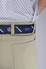Close-up of an outfit showing a beige pants with a navy belt. The belt features white and green stripes, a thistle emblem, and the number 1872.