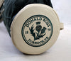 Cream-colored golf ball marker displaying the Donald Ross Dornoch, UK circular emblem with thistle design and 1872 date marking.
