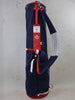 MacKenzie & Donald Ross navy and red golf bag with thistle emblem and shoulder strap displayed against a neutral background.