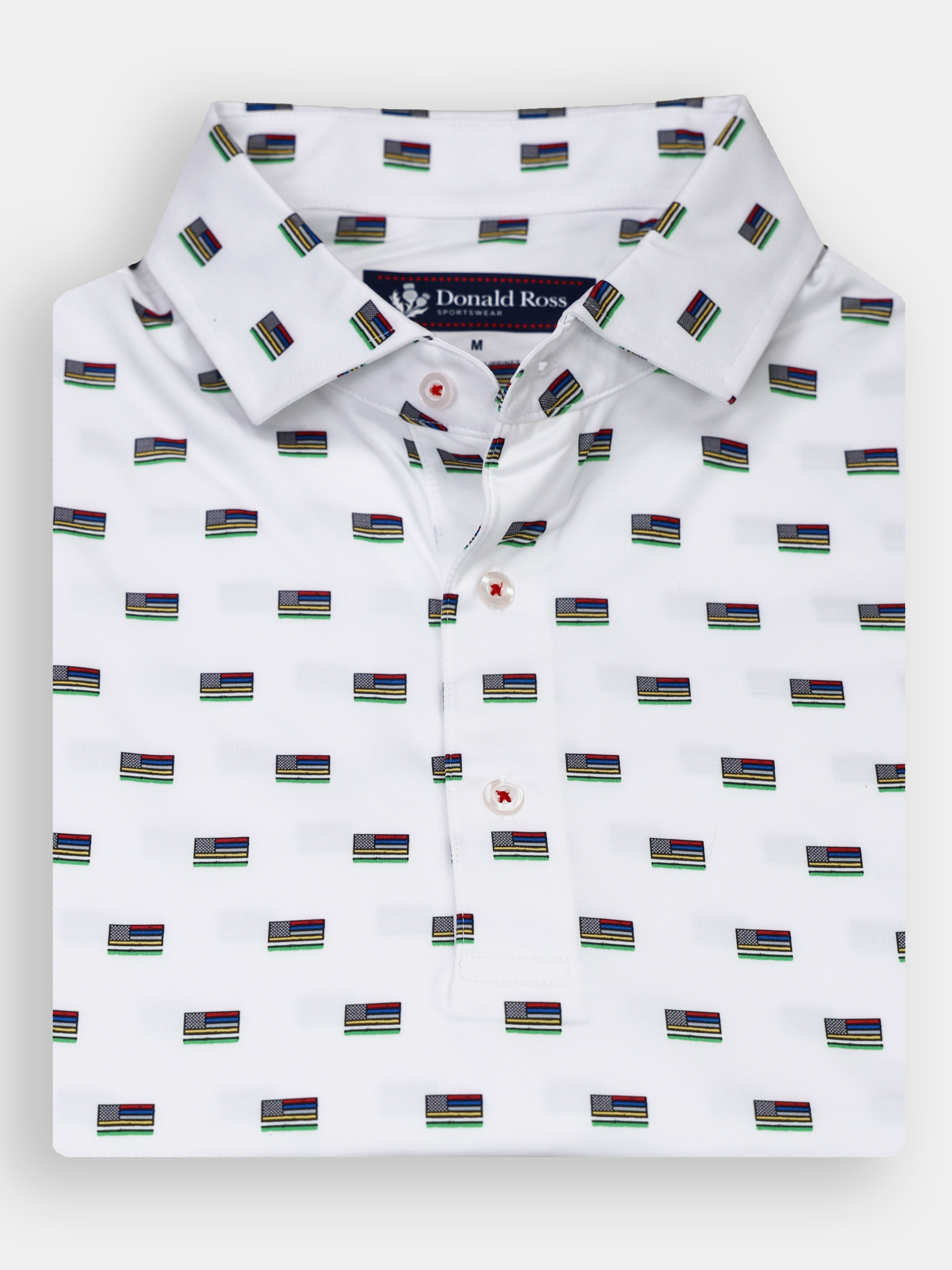 A white collared shirt is folded neatly and features a repeating pattern of small flags in various colors.