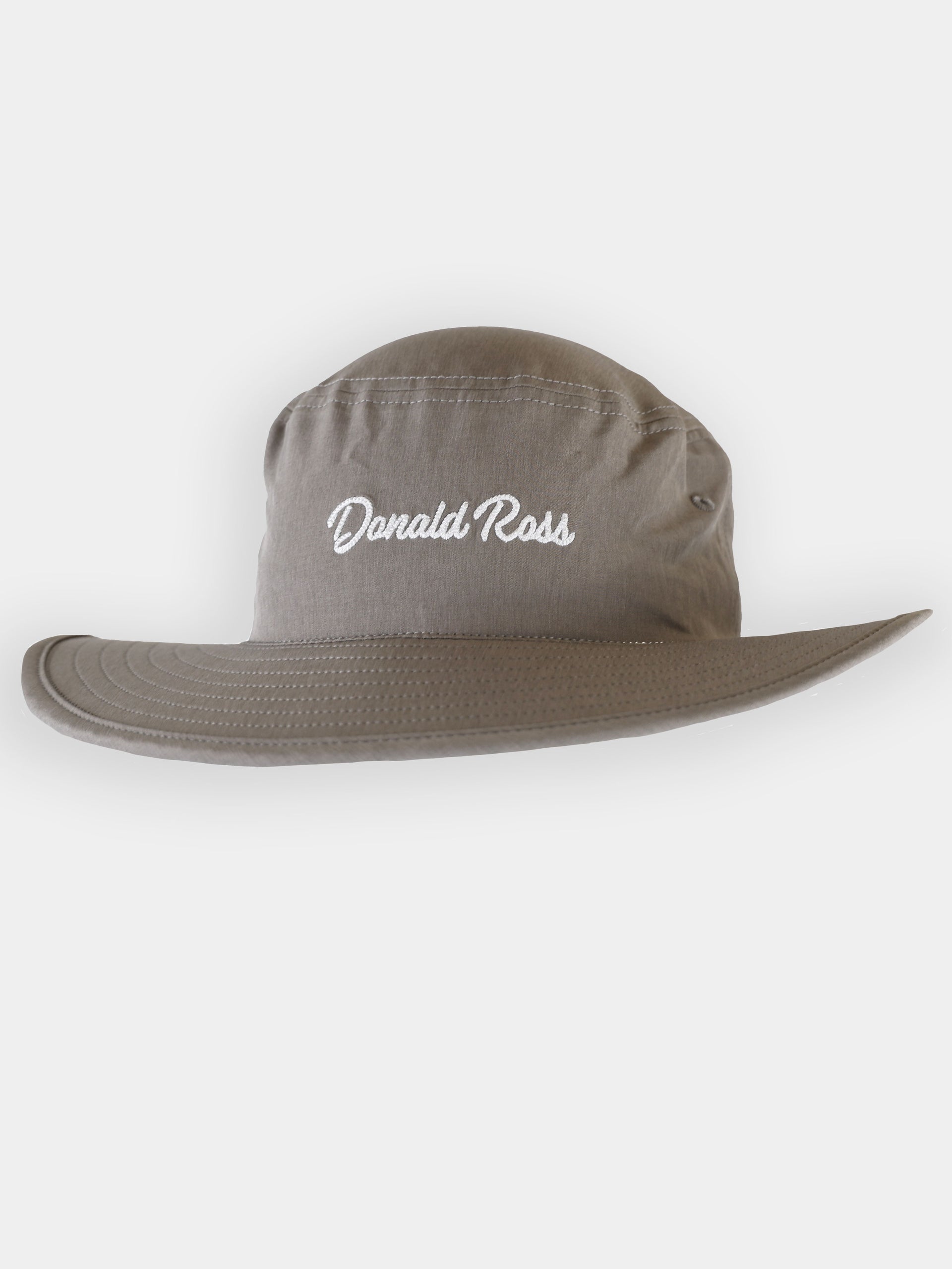 A light grey bucket hat with a floppy 2 1/4 inch brim and the name Donald Ross embroidered in navy blue script on the front crown.