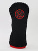 Black knit golf club headcover with red circular logo featuring crossed clubs and "DJUR" lettering, finished with red trim at the base.