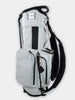 White and black golf cart bag with multiple pockets, dual shoulder straps, and a reinforced base displayed against a neutral background.