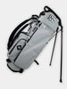 Light gray golf stand bag with black trim and shoulder strap displayed against a white background.