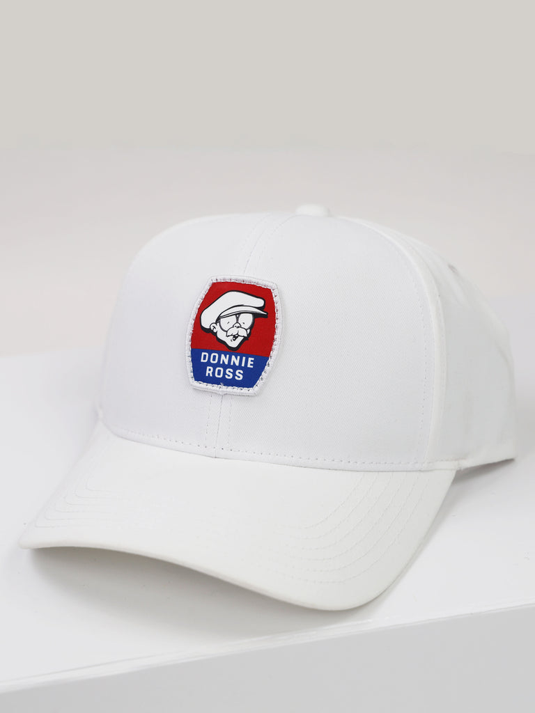 White baseball cap featuring a red and blue embroidered Donnie Ross logo patch on the front.