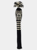 Black and cream knit golf club head cover with striped pattern, tasseled top, and embroidered thistle crest.