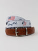 A tan leather belt with a signature patriotic web strap featuring American flag imagery and the number 250, paired with a brushed nickel buckle.