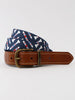 Cognac leather belt with brass buckle and contrasting navy, red, and cream patterned fabric overlay.