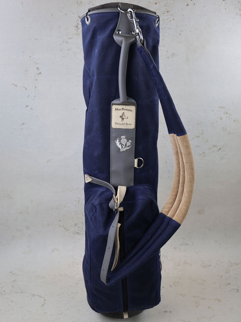 Navy canvas golf bag with tan accents and gray leather shoulder strap featuring MacKenzie and Donald Ross branding.