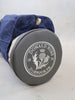A gray leather golf ball marker bearing the Donald Ross Dornoch, U.K. crest sits beside a navy velvet pouch.