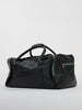 Black leather travel bag with green zippers, featuring two sturdy handles and front pocket, placed on a white background