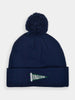 A navy blue knit beanie with a pom-pom on top. The turned-up brim features a green pennant with "Donald Ross" embroidered in white