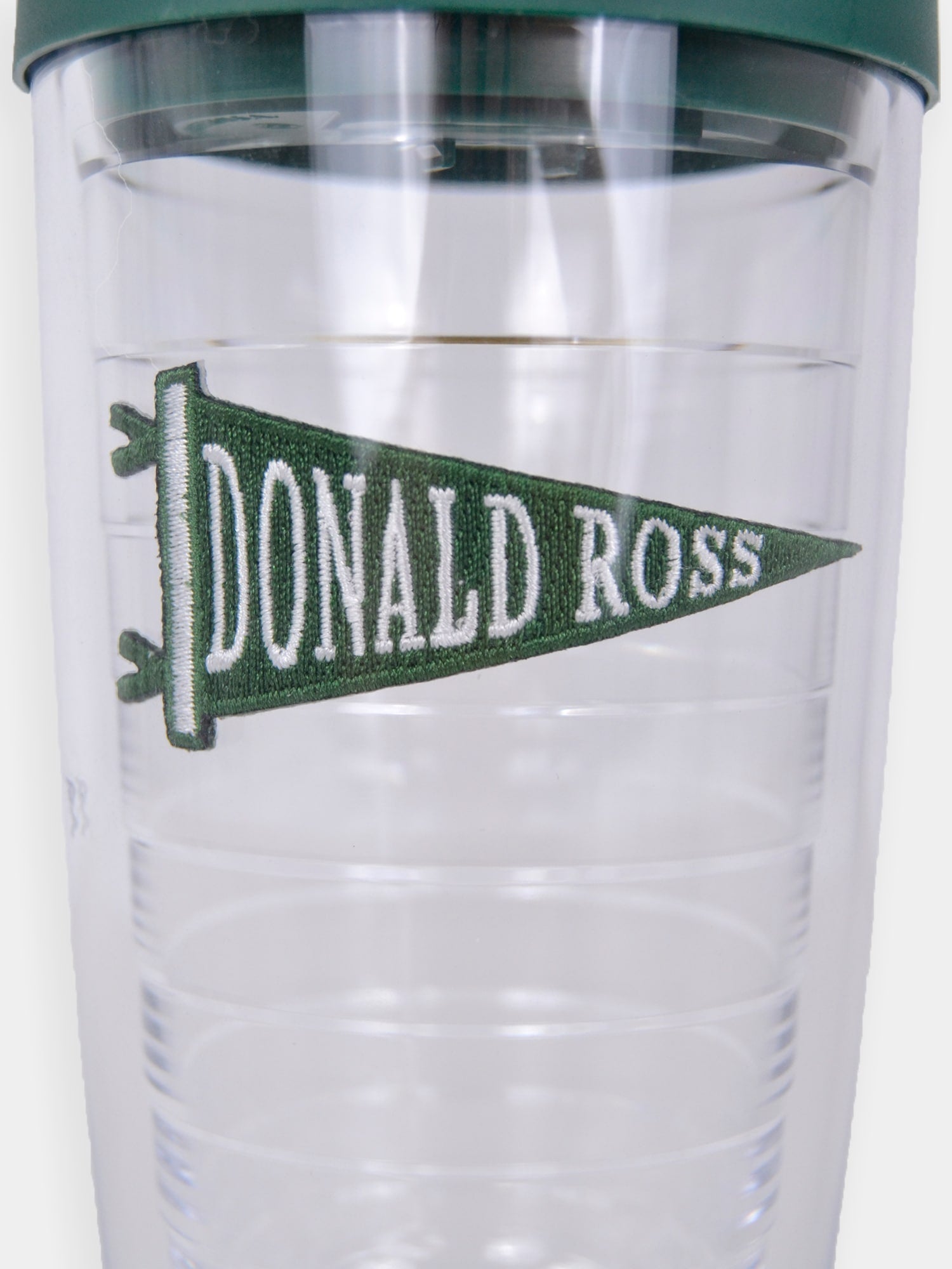 Clear tumbler with a dark green lid featuring a green pennant that displays "Donald Ross" in white text.