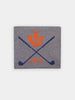 Gray label with a design featuring crossed blue golf clubs, an orange thistle emblem, and the year "1872" in orange.
