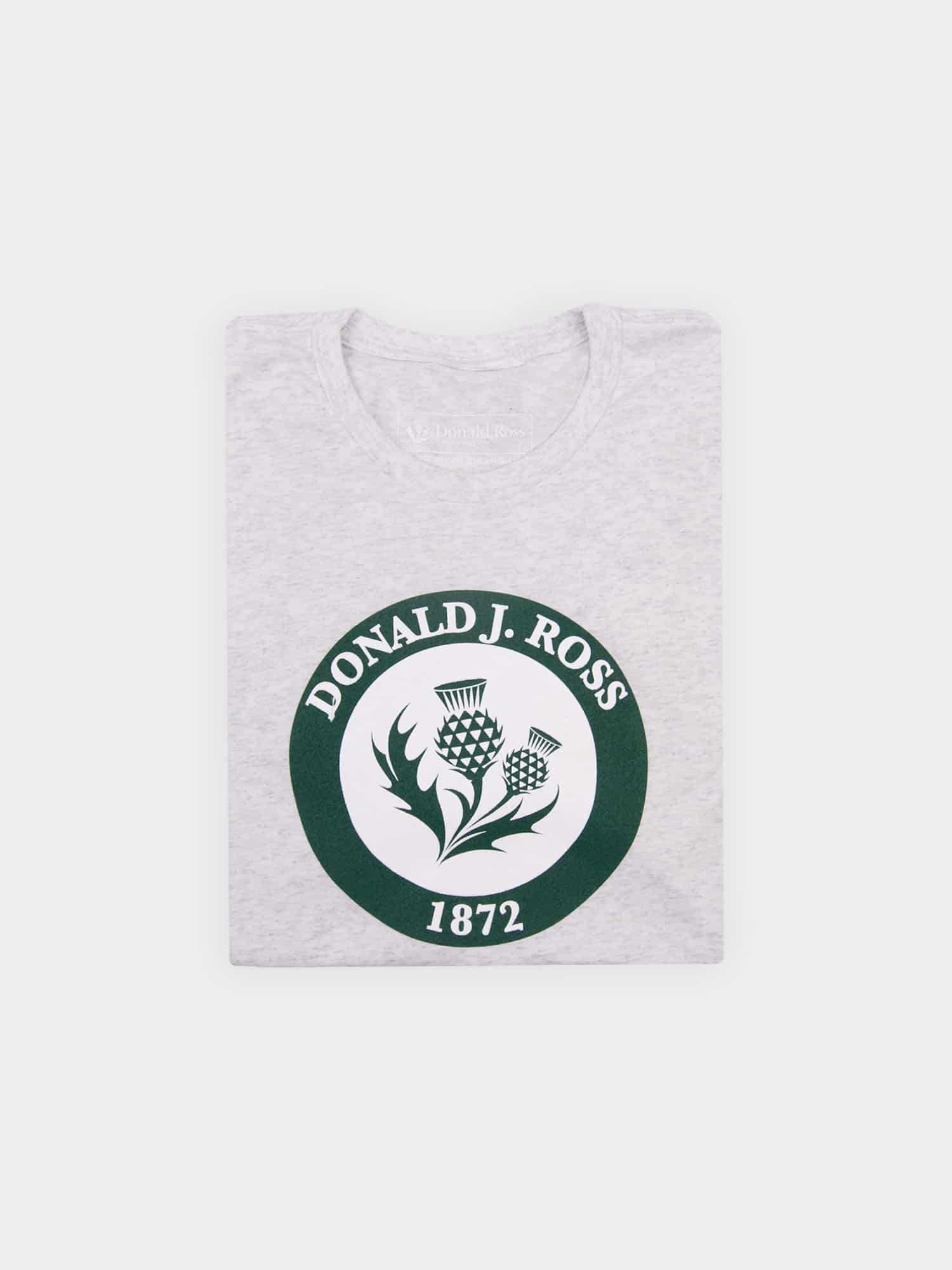 Gray T-shirt featuring a green circular emblem with two thistles and the text "Donald J. Ross 1872" in white. Simple, classic design.