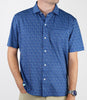 Man wearing a royal blue short-sleeve button-up shirt with a subtle all-over geometric pattern and white pearl buttons.
