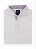 Folded white polo shirt with a multicolored floral pattern inside the collar. It has three buttons with red accents, creating a stylish and neat appearance.