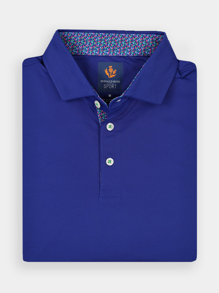 Folded royal blue polo shirt with contrasting patterned collar lining and three buttons