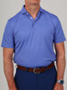 Man wearing a light blue polo shirt and dark blue pants with a brown belt. His watch is visible on his left wrist.