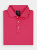 Folded bright pink polo shirt with three white buttons and a collar, featuring a navy label with orange logo on the inside