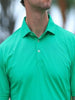 A man in a vibrant green polo shirt is shown from the shoulders up, facing slightly to the side