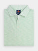 A folded light green and white striped polo shirt with a buttoned collar, featuring performance golf fabric