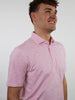 Smiling man in a pink and white striped polo shirt against a plain white background