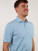 Smiling man in blue striped polo shirt, looking upward with joy. Neutral background enhances focus on his cheerful expression and casual attire