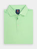 Folded mint green polo shirt with a branded label at the collar, featuring three buttons