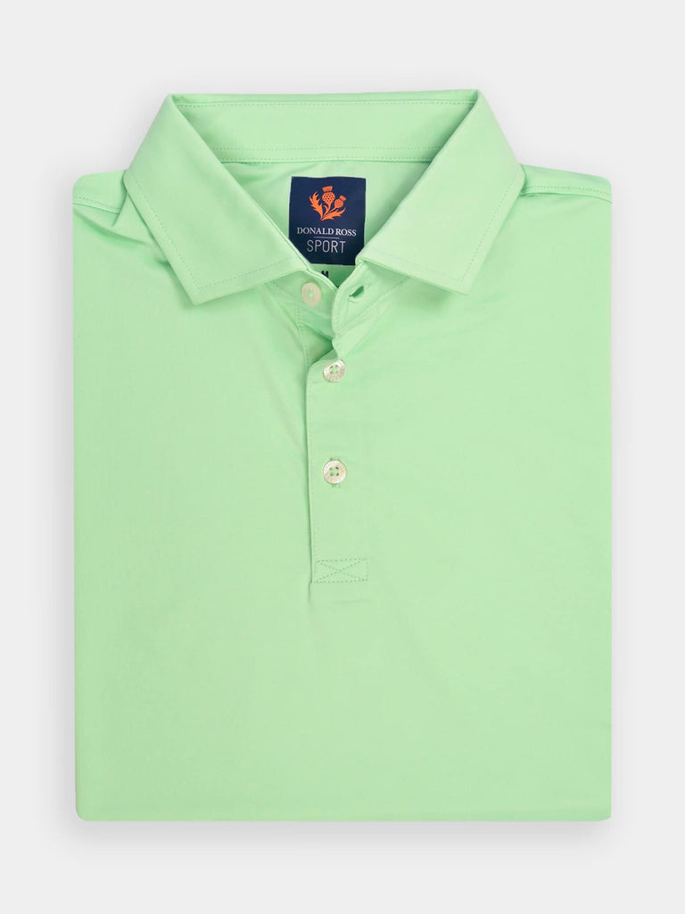 Folded mint green polo shirt with a branded label at the collar, featuring three buttons
