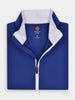 Folded blue sports jacket with a white collar and zipper on a white background
