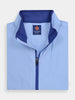 Folded light blue jacket with a dark blue inner collar and zipper, featuring premium fabrics