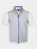 A sleeveless light gray vest with a blue zipper is displayed over a short-sleeved white shirt. The look is clean and modern, exuding casual elegance.