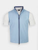 Light blue zip-up vest over a white short-sleeve shirt. The vest has a dark blue trim and a standing collar, conveying a clean, sporty look