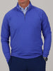 A neatly folded Louie mid-weight 1/4 zip pullover in iris blue highlighting the performance fabric and mock neck.