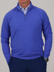 A neatly folded Louie mid-weight 1/4 zip pullover in iris blue highlighting the performance fabric and mock neck.