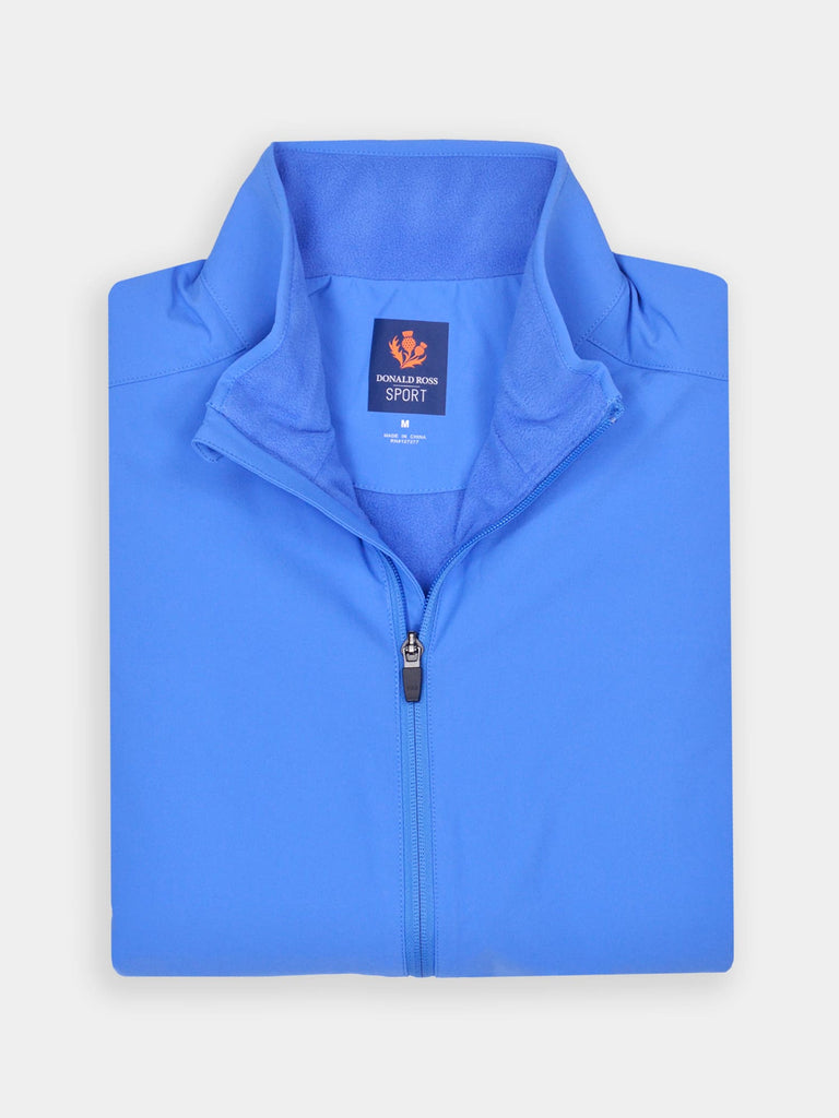 Folded bright blue quarter-zip performance vest for golfers
