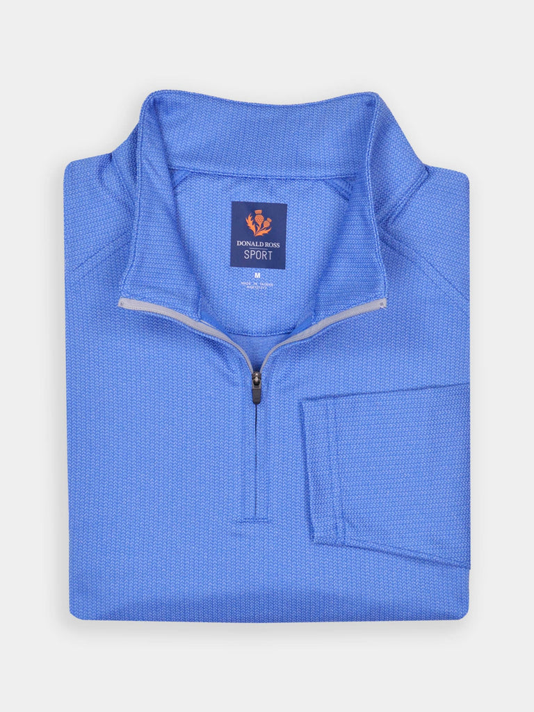 A folded, blue quarter-zip pullover with a woven texture, featuring performance moisture-wicking fabric