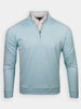 Light blue long-sleeve quarter-zip pullover displayed against a white background. Beneath the pullover, a white button-up shirt is visible, creating a layered look